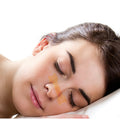 A nasal strip worn across the bridge of the nose during sleep